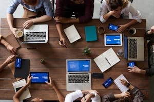 Top View Photo Of People Near Wooden Table